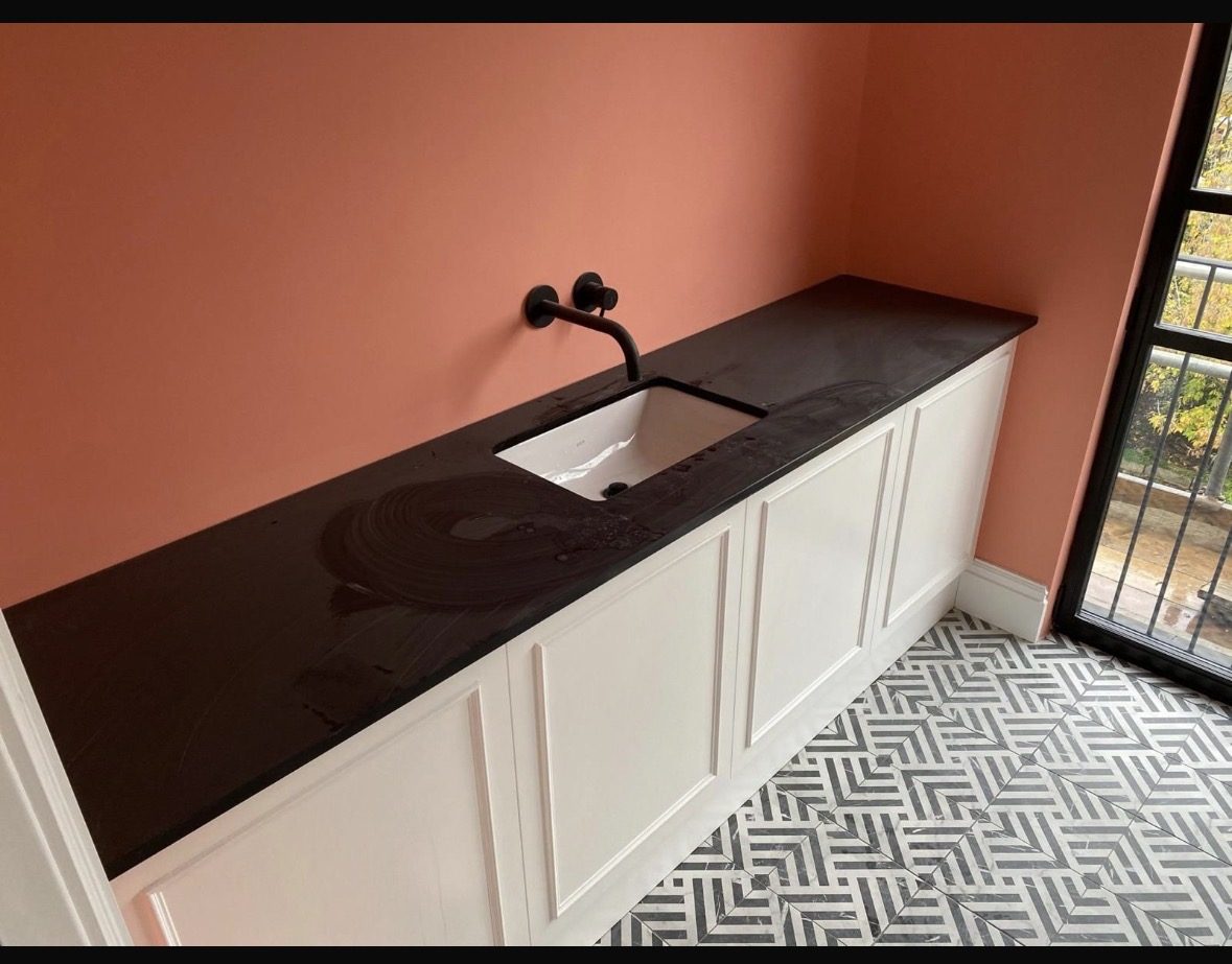 Black stone vanity with undermount basin and matt-black tap